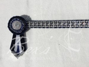 3/4" Crystal Show Browband: Navy velvet background, Silver diamond crystal chain woven on with Silver cord. Pleated rosettes with Silver centres. V shaped tails with Silver crystal flag tips